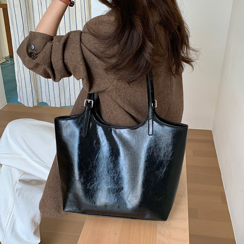 Black Minimalist Tote Bag worn on shoulder