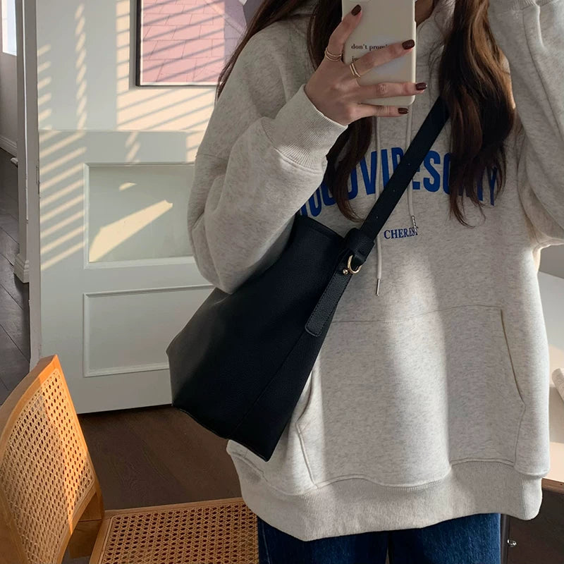Black Minimalist Tote Bag worn on shoulder