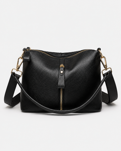 Front view of black PORT&LOTUS pebbled vegan leather crossbody bag with curved handle and adjustable shoulder strap