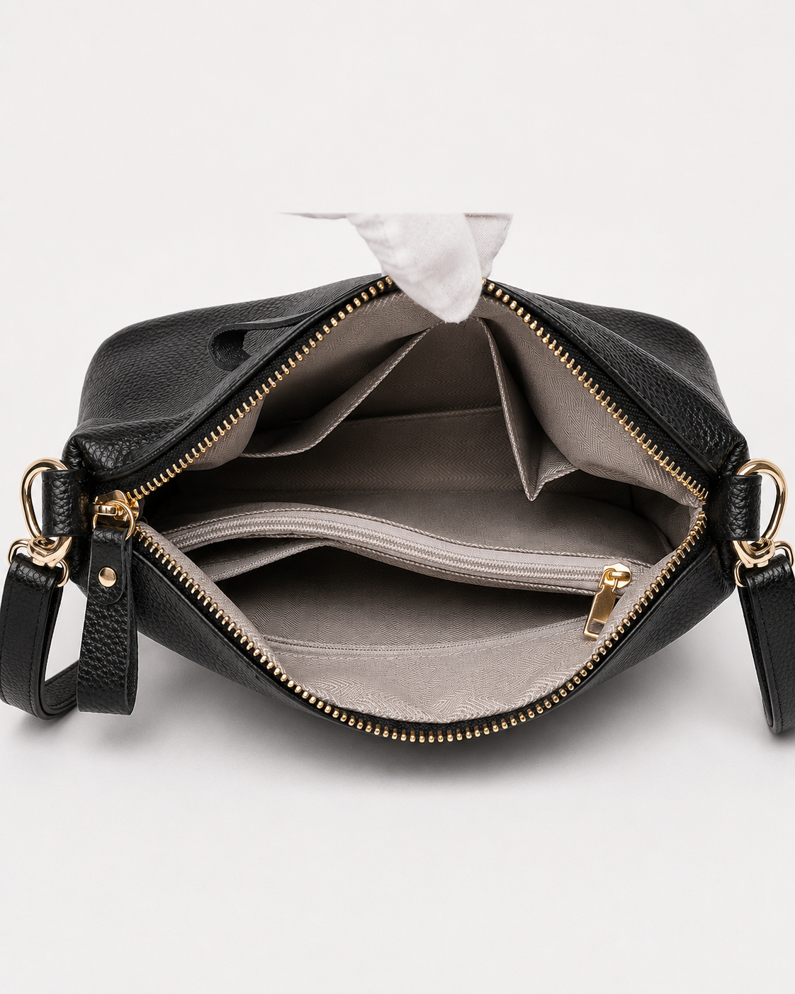 Open black PORT&LOTUS crossbody bag showing organized interior compartments with divider pockets and zip section