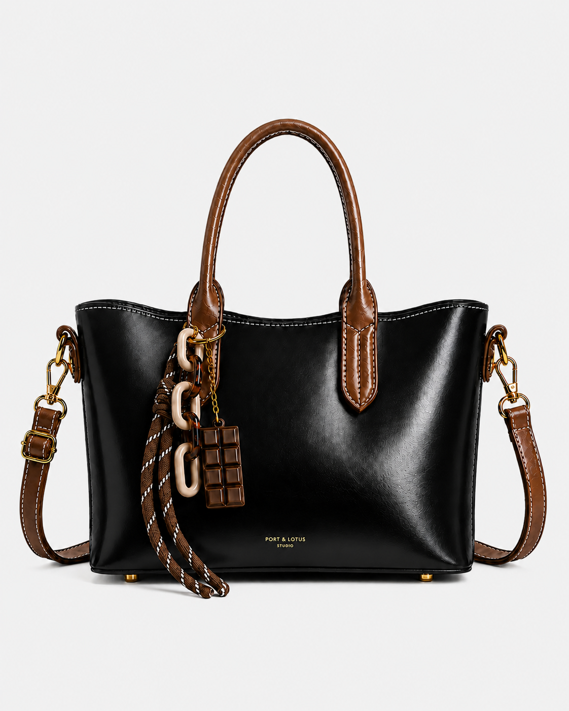 PORT&LOTUS black tote handbag with contrasting brown handles detachable shoulder strap decorative charms and gold-tone hardware