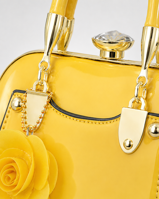 Port&Lotus yellow patent leather vintage frame handbag closeup yellow rose charm crystal kisslock clasp
