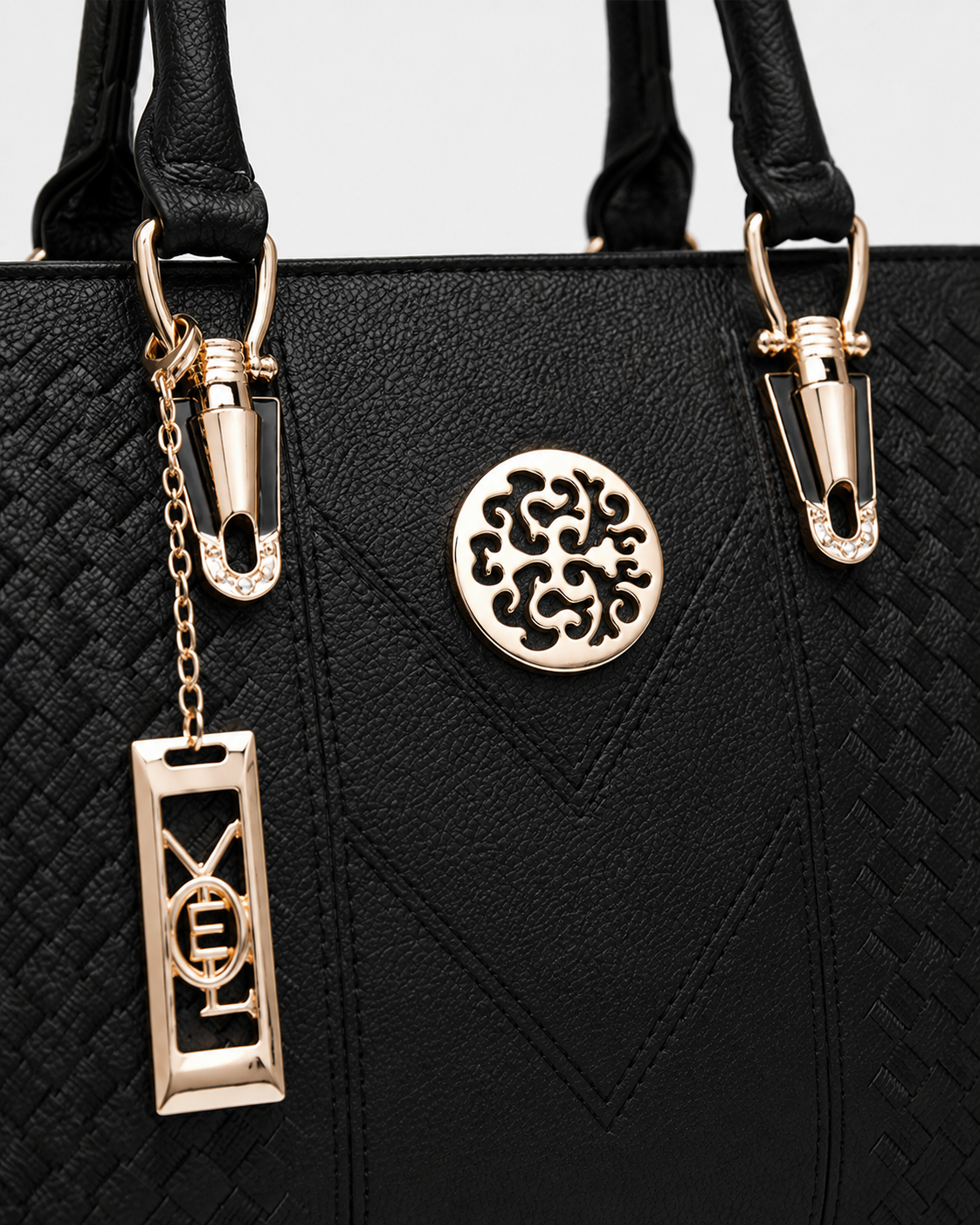 port&lotus black braided leather women tote bag circular cutout metal plaque letter chain charm gold tone fitting top handle bag detail