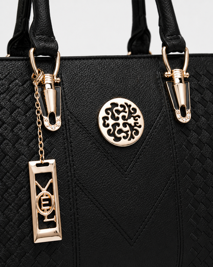port&lotus black braided leather women tote bag circular cutout metal plaque letter chain charm gold tone fitting top handle bag detail
